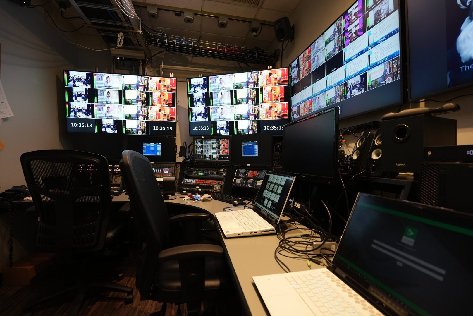 A room with many monitors and laptops