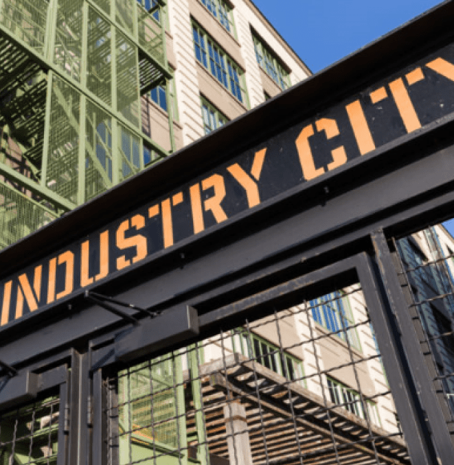 A sign that says industry city in front of some buildings.