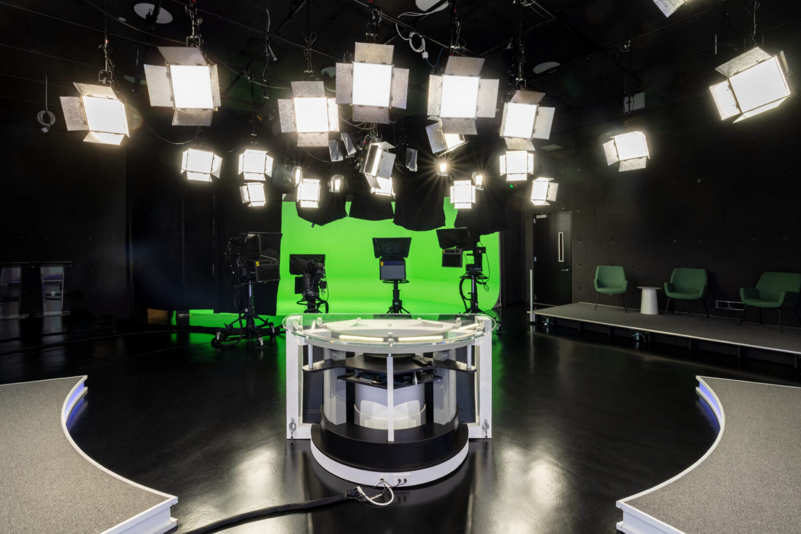 Television studio with green screen and lights.